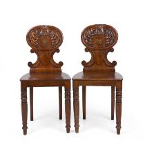 A pair of early Victorian mahogany hall chairs with painted crests, panel seats and turned legs 40cm