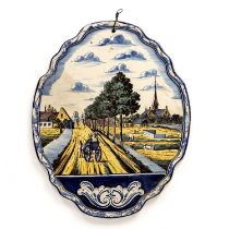 An 18th century Dutch Delft wall plaque depicting a canal scene 34cm x 42cm some crazing, dated 1742