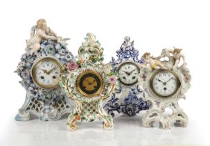 Three French porcelain boudoir mantel clocks/timepieces with putti and floral decoration and a Delft