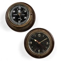 A brass ships bulk head timepiece, the black dial with white Arabic numerals and hands, red centre