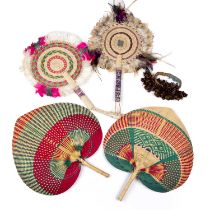 Four Solomon Islands woven wicker and feather dance fans 31cm wide 36cm high together with a seed