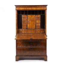 An early 18th century walnut escritoire with quarter cut veneer, cross and feather banding, the fall