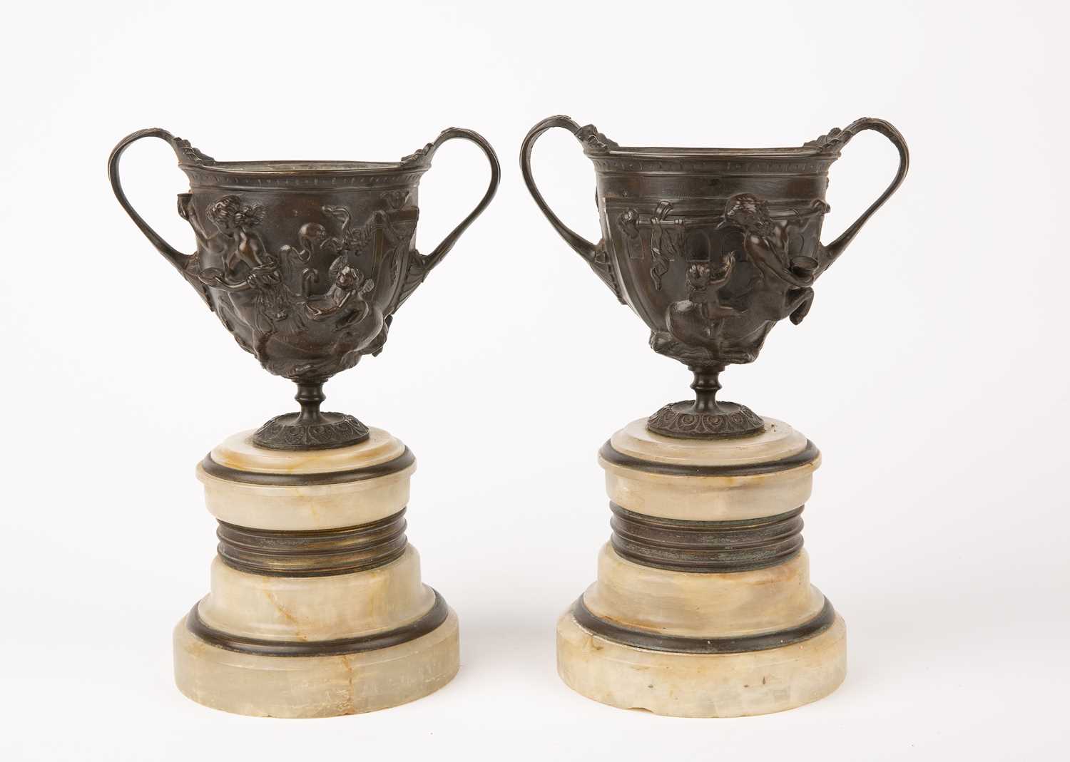 A pair of 19th century Grand Tour bronze urns with Centaurs in relief and mounted on alabaster socle - Image 2 of 2
