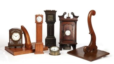 A George III mahogany wall hanging watch holder, two miniature longcases with watch movements, a