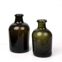 Two 18th century glass bottles 21cm high and 18.5cm high. Provenance: Malcolm Deas Collection Some