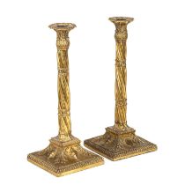 A pair of 19th century gilded metal candlesticks with spiral stems and square weighted bases. 13cm