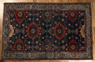 Blue ground Caucasian rug with geometric designs and a panelled border, 201cm x 130cm With some