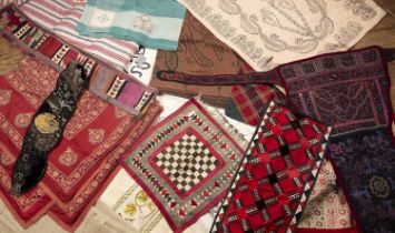 Group of textiles including a Kashmir panel, a Chinese baby carrier, a Turkmenistan patchwork cover,