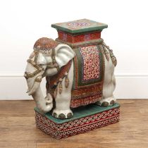 Pottery elephant on stand the elephant cream coloured, with an ornate polychrome saddle and