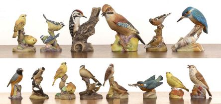Collection of twelve Royal Worcester bird figure groups all in matt glaze, including a large model