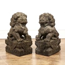 Pair of reconstituted stone temple dogs in the Chinese manner, 50cm high (2) Weather worn.