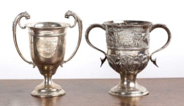 Two silver trophy cups one with twin leopard head handles, on a circular socle base, bearing marks