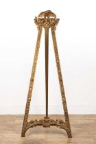 Ornate gilt easel with later pegs for adjustable height of the canvas, an eagle perched at the top