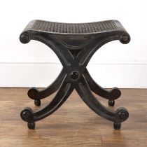 Mahogany bergere stool in the form of an 'x', with volute-style carved details, on ball feet, 47cm