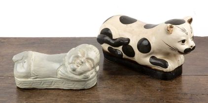 Two Chinese pillows one in the form of a boy in a cizhou style and the other celadon glazed in the