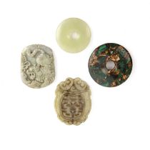 Four Chinese carved pendants or bi discs 20th Century, one a malachite bi disc, 5cm across, a