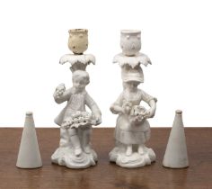Pair of Derby porcelain figural candlesticks blanc de chine finish, with underglaze crossed swords