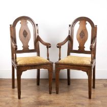 Pair of armchairs Indian, late 19th/early 20th Century, with arched backs and carved decoration in