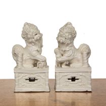 Pair of blanc de chine temple dogs Chinese, contemporary, standing on plinths, unmarked, 21cm high