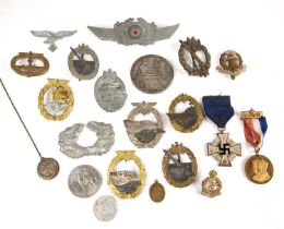 Collection of WWII German military badges including a faithful service medal, Navy badges, George VI