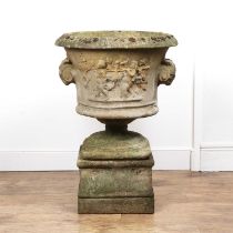 Large classical style reconstituted stone urn on a pedestal base, with mask head, putti and vines,