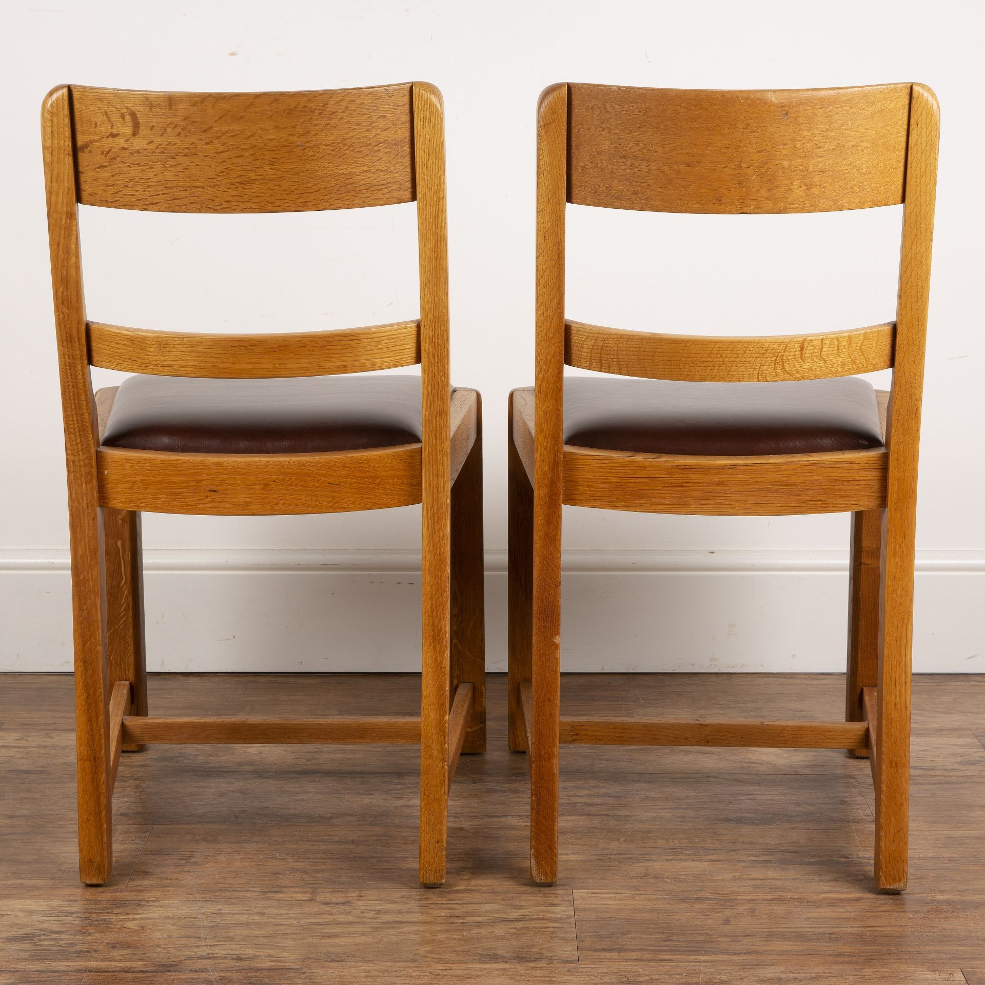 Attributed to Heals pair of oak-framed chairs with bar backs, reupholstered red seats, with stylised - Image 2 of 2