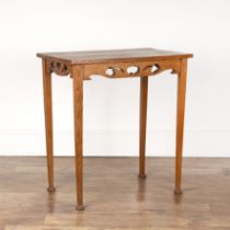 In the manner of Liberty & Co oak, table with cut out supports, standing on stepped feet, 69cm