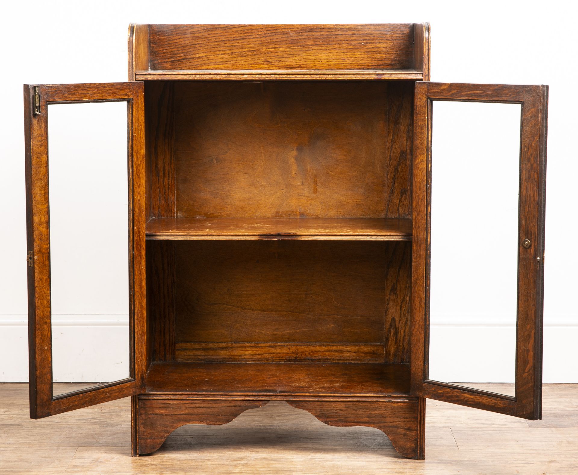 Attributed to Heals oak cupboard, with galleried top, two glazed panel doors with a turned wooden - Image 2 of 5