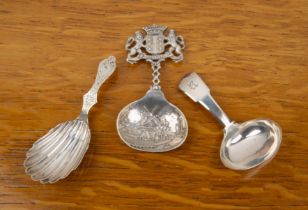 Three silver caddy spoons comprising a Victorian silver exampled with shell formed bowl, bearing