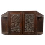 Arts and Crafts Oak cupboard, with carved grape vine decoration, twin doors enclosing a shelf,