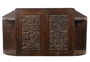 Arts and Crafts Oak cupboard, with carved grape vine decoration, twin doors enclosing a shelf,