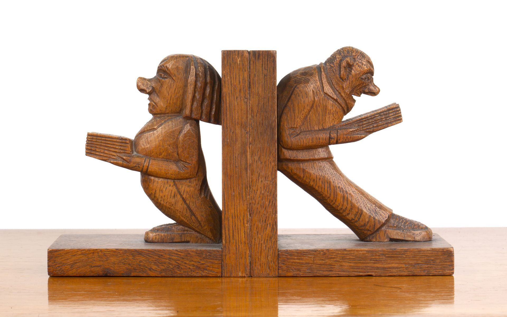 Pair of carved figural bookends oak, 1930s, modelled as two figures reading, unsigned, each