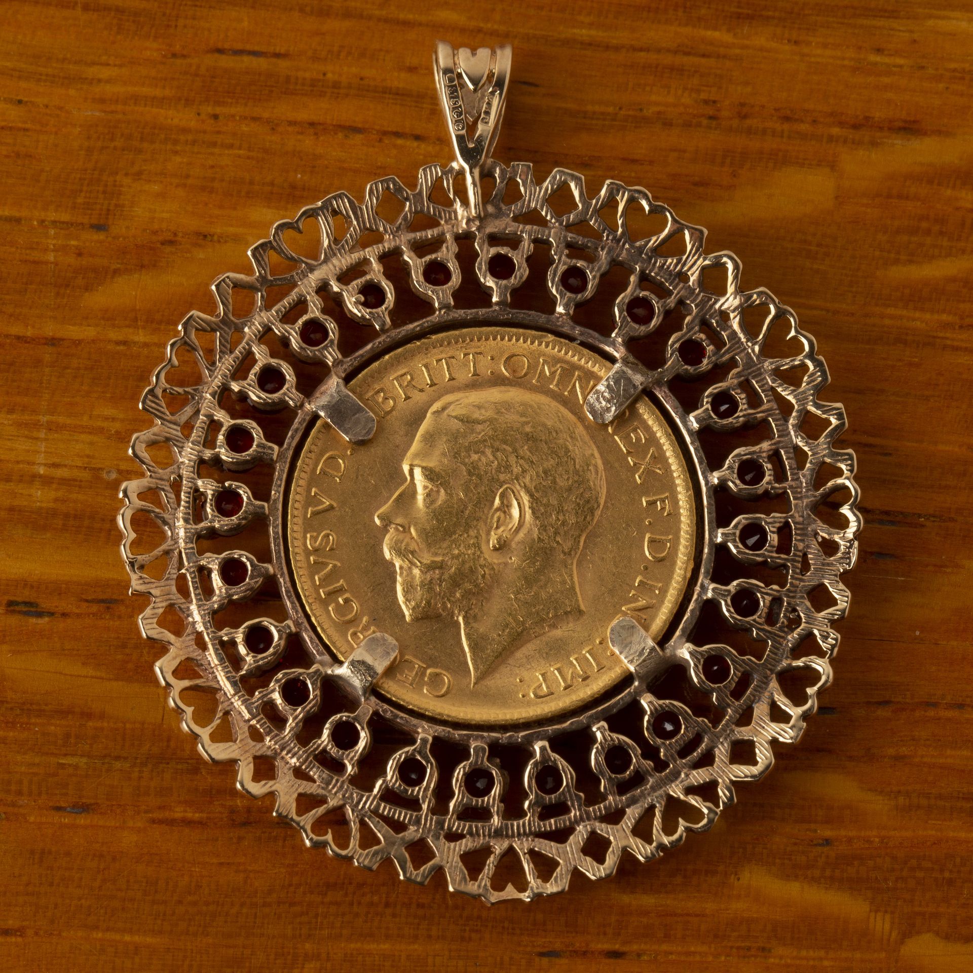 George V sovereign dated 1914, set in a 9ct gold pendant mount, set with garnets, 15g approx overall - Image 2 of 2