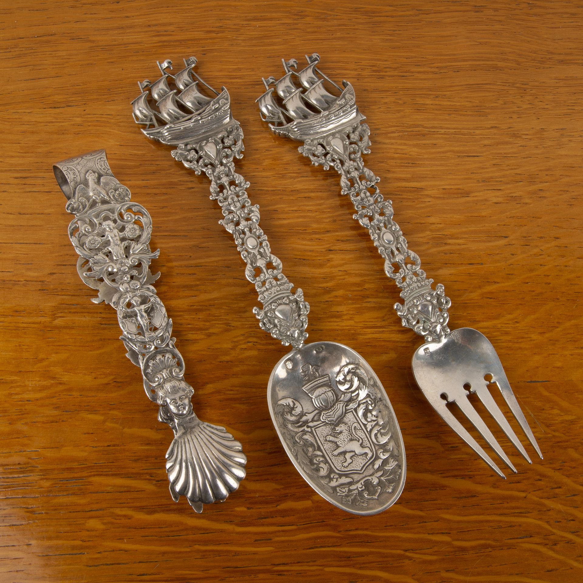 Collection of Continental (Possibly Dutch) silver items comprising a pair of tongs, with shell