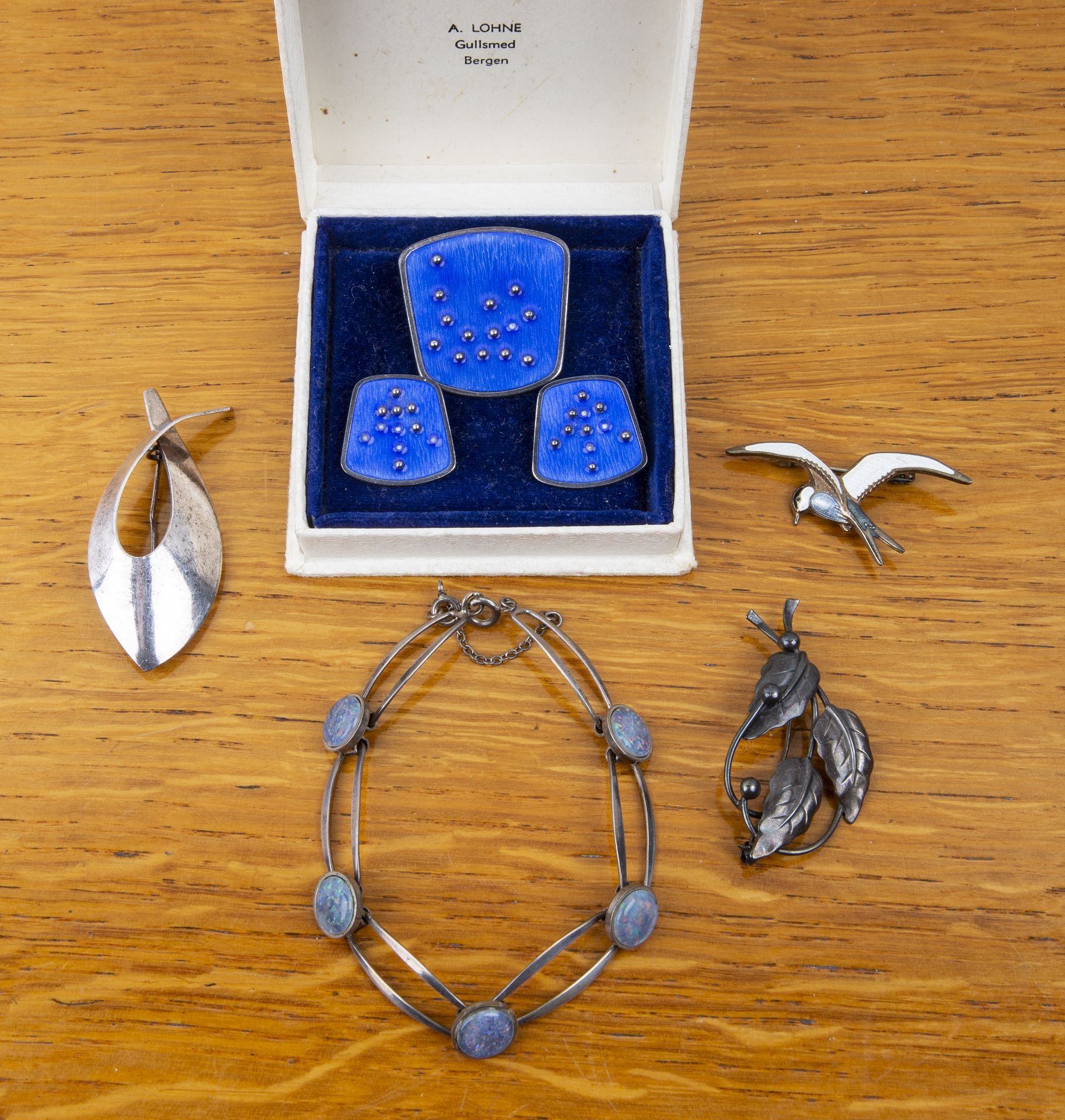 Group of jewellery comprising: a white metal and faux opal panel bracelet, stamped 835, a David