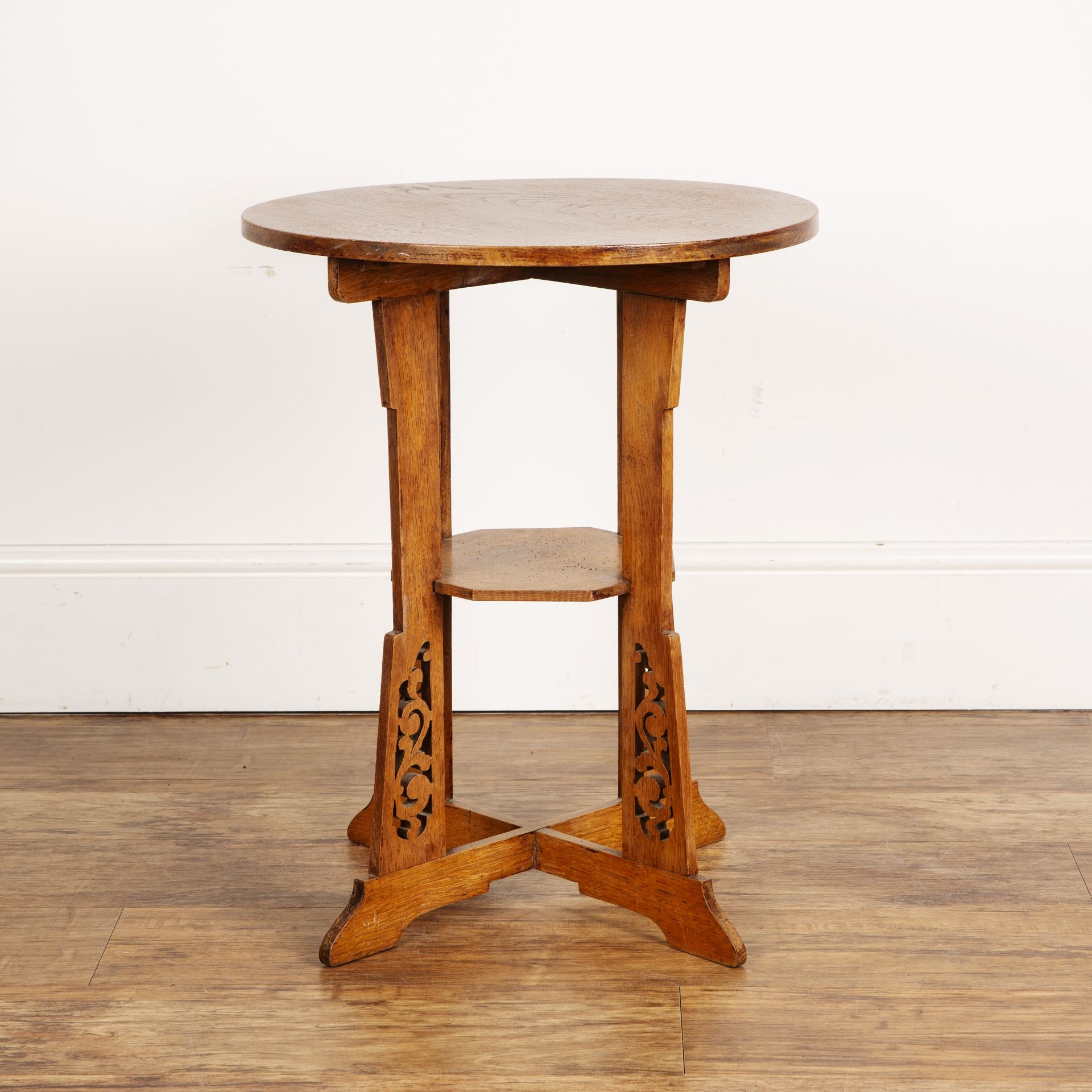Aesthetic movement oak, circular topped table with open fret carved supports on cross stretchers,