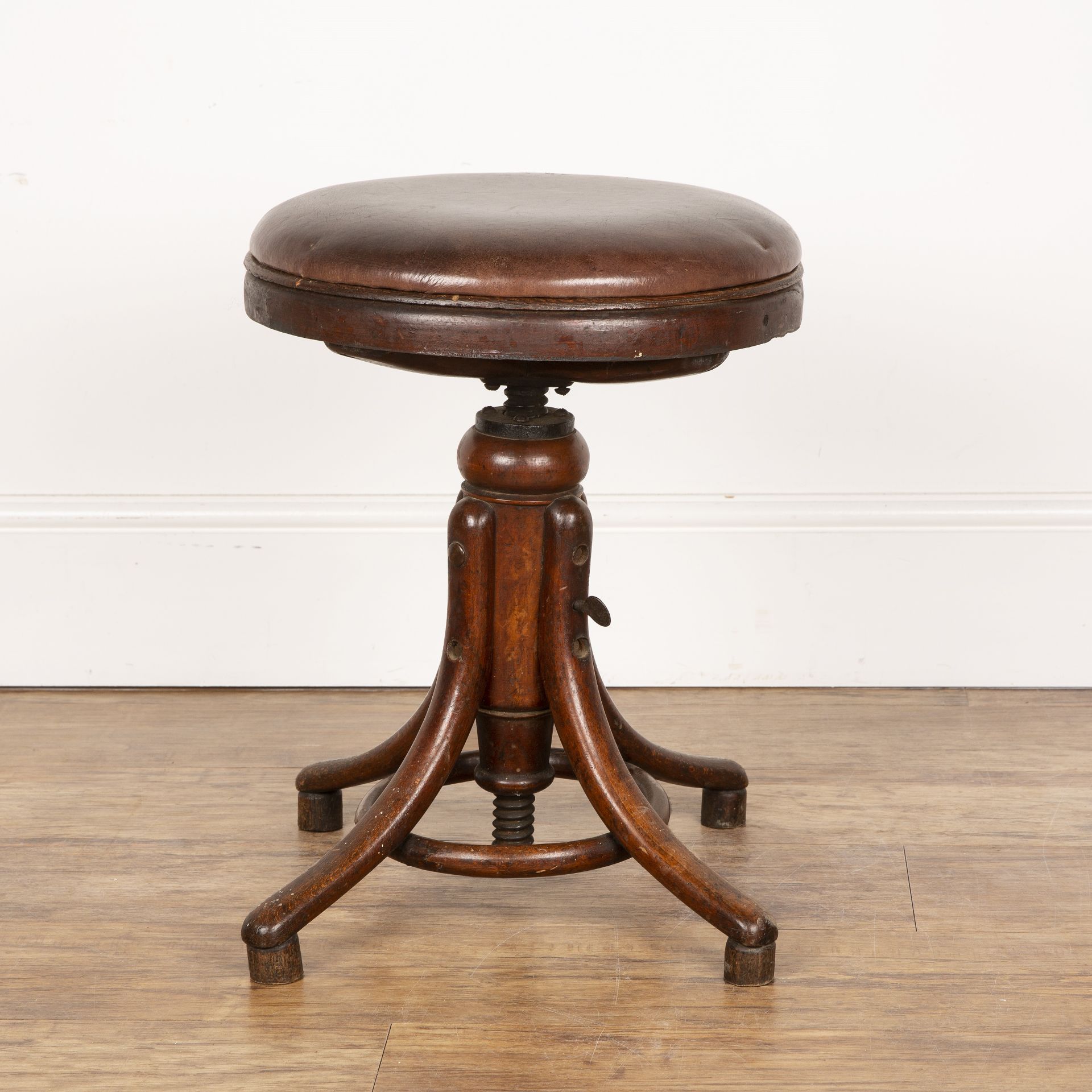 In the manner of Thonet industrial swivel stool, with leather top on bentwood base, unmarked, 55cm
