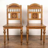 Aesthetic movement pair of oak hall chairs, with carved top rail and back supports, the seat with