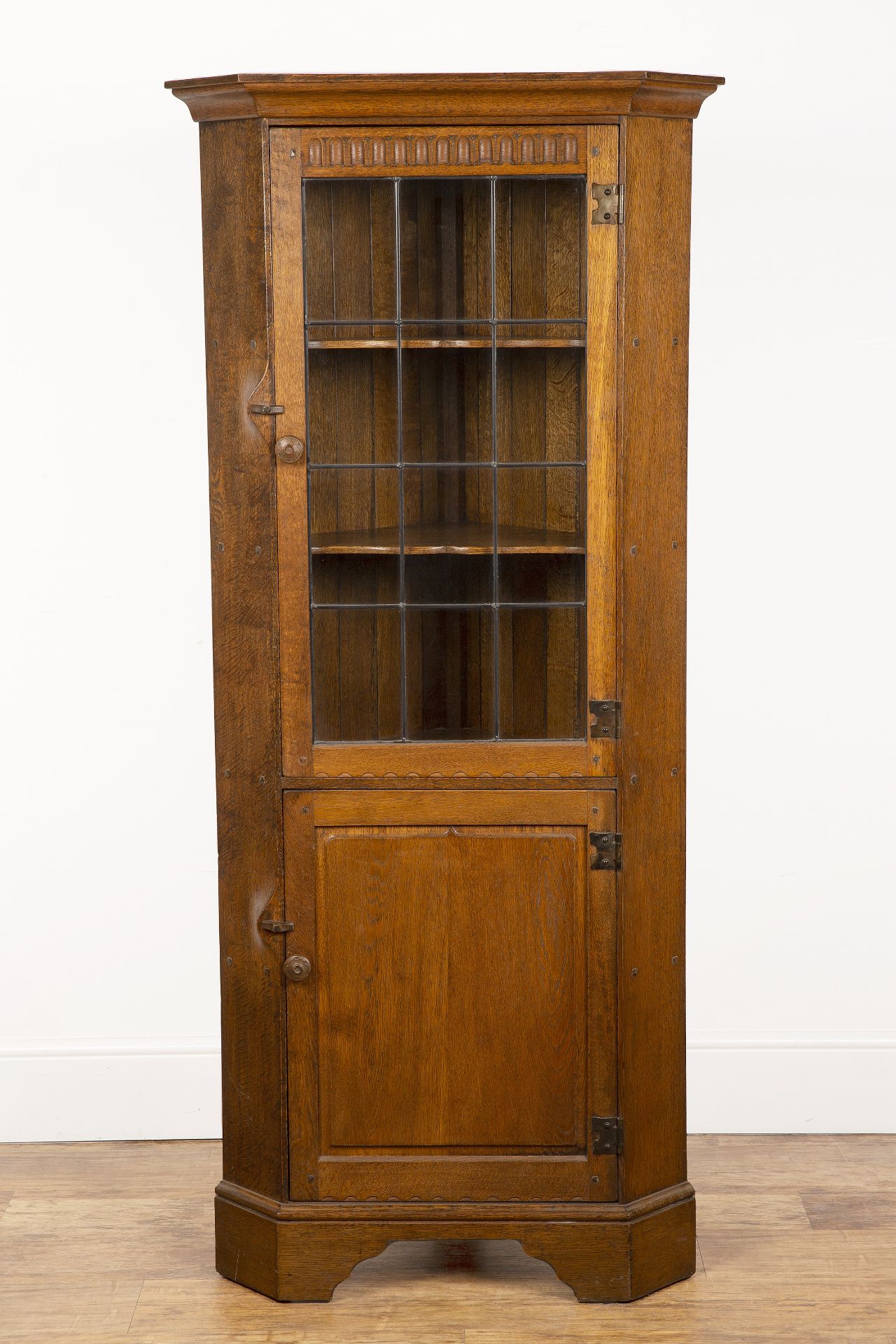 Yorkshire School oak, corner display cabinet, with astragal glazed door above a fielded panel