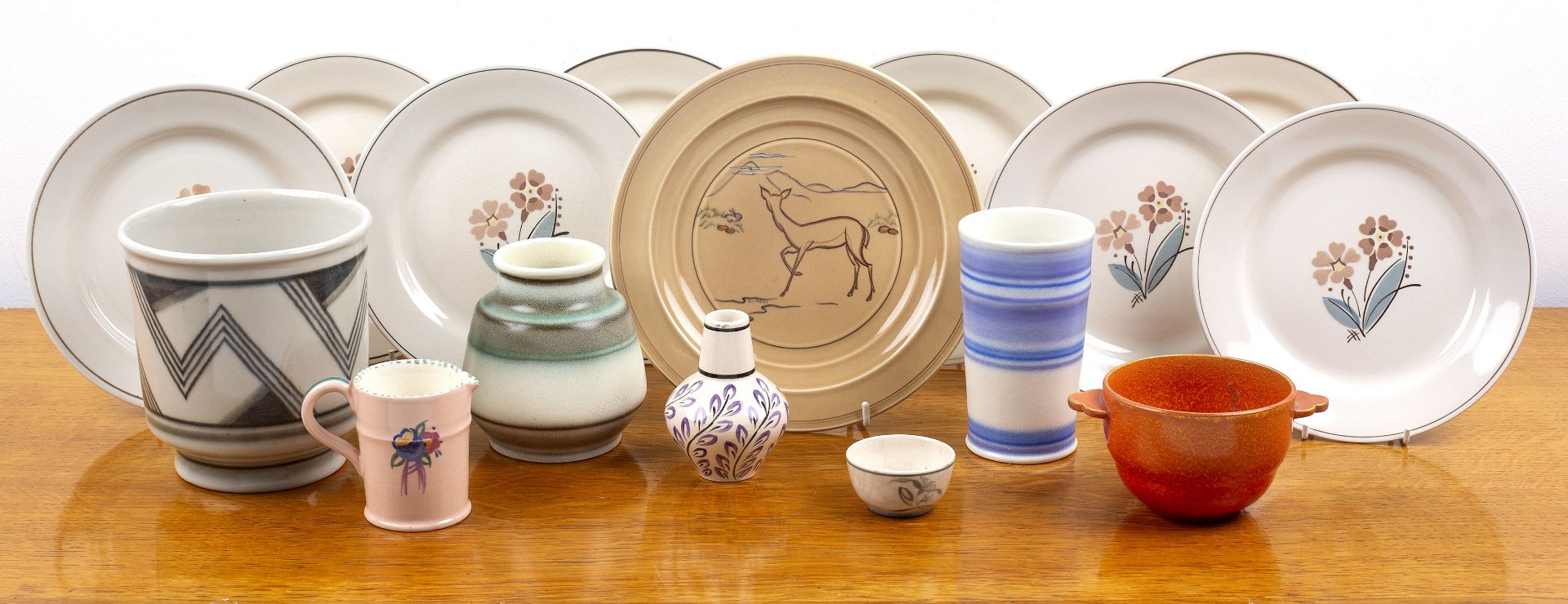 Collection of various Poole Pottery including a set of eight floral plates, decorated by Ruth