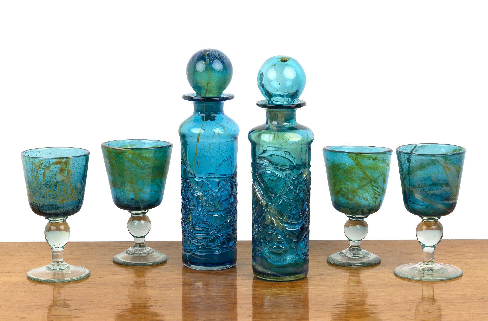 Group of Mdina glassware to include: two trailed glass decanters with stoppers, four goblets, two