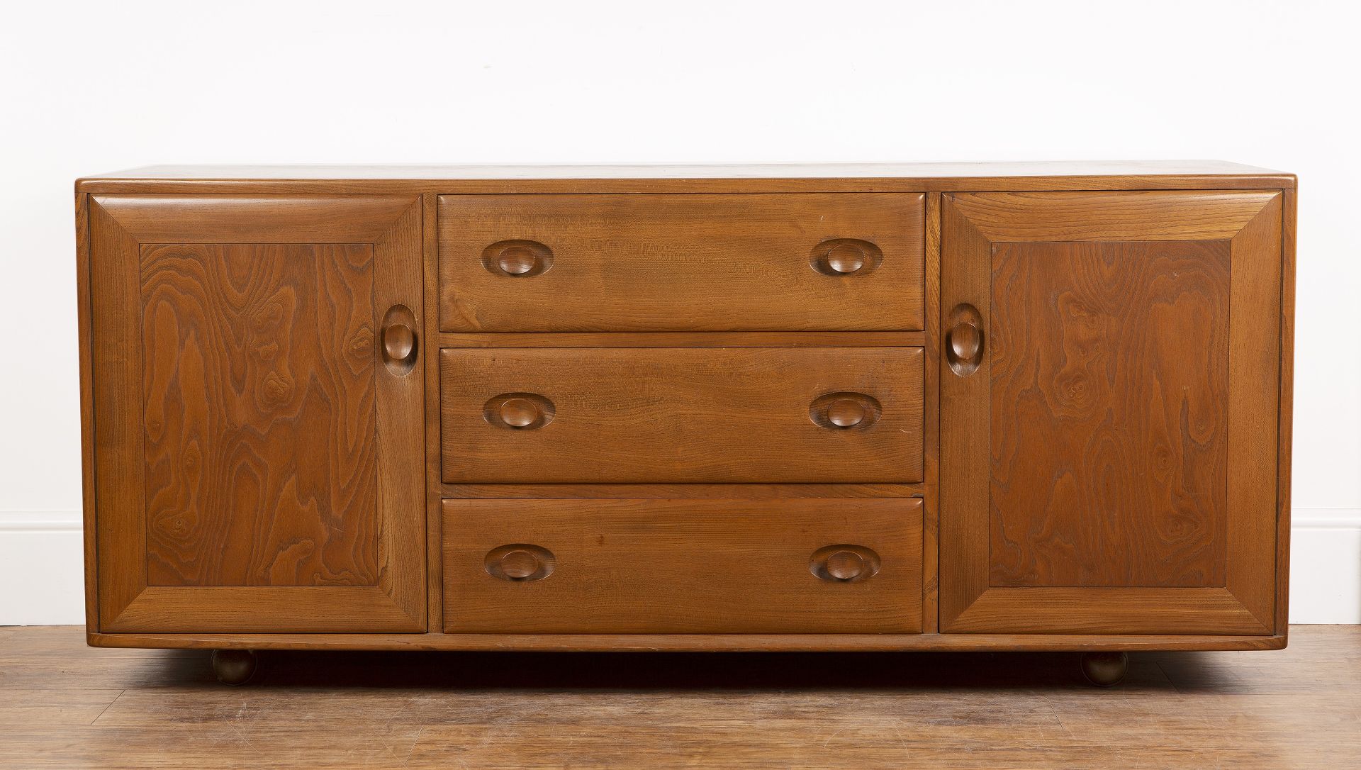 Luciano Ercolani (1888-1976) for Ercol elm sideboard, fitted with two cupboards and three central