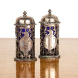 Pair of Edward VII silver pepperettes with pierced decoration of birds and foliage, with blue