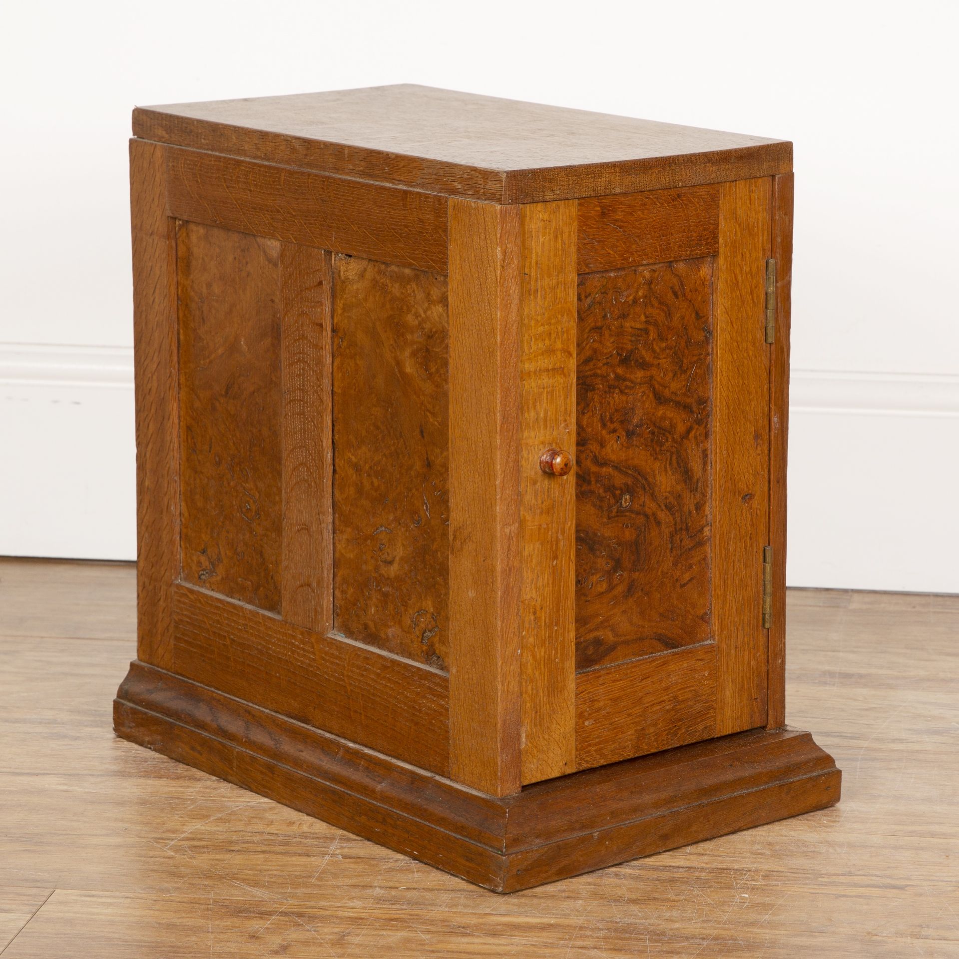 Cotswold School oak and burr walnut tabletop cupboard, with panelled doors and sides, on plinth
