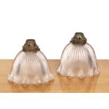 Two Holophane glass ceiling lights with ribbed decoration and pierced brass galleries, with