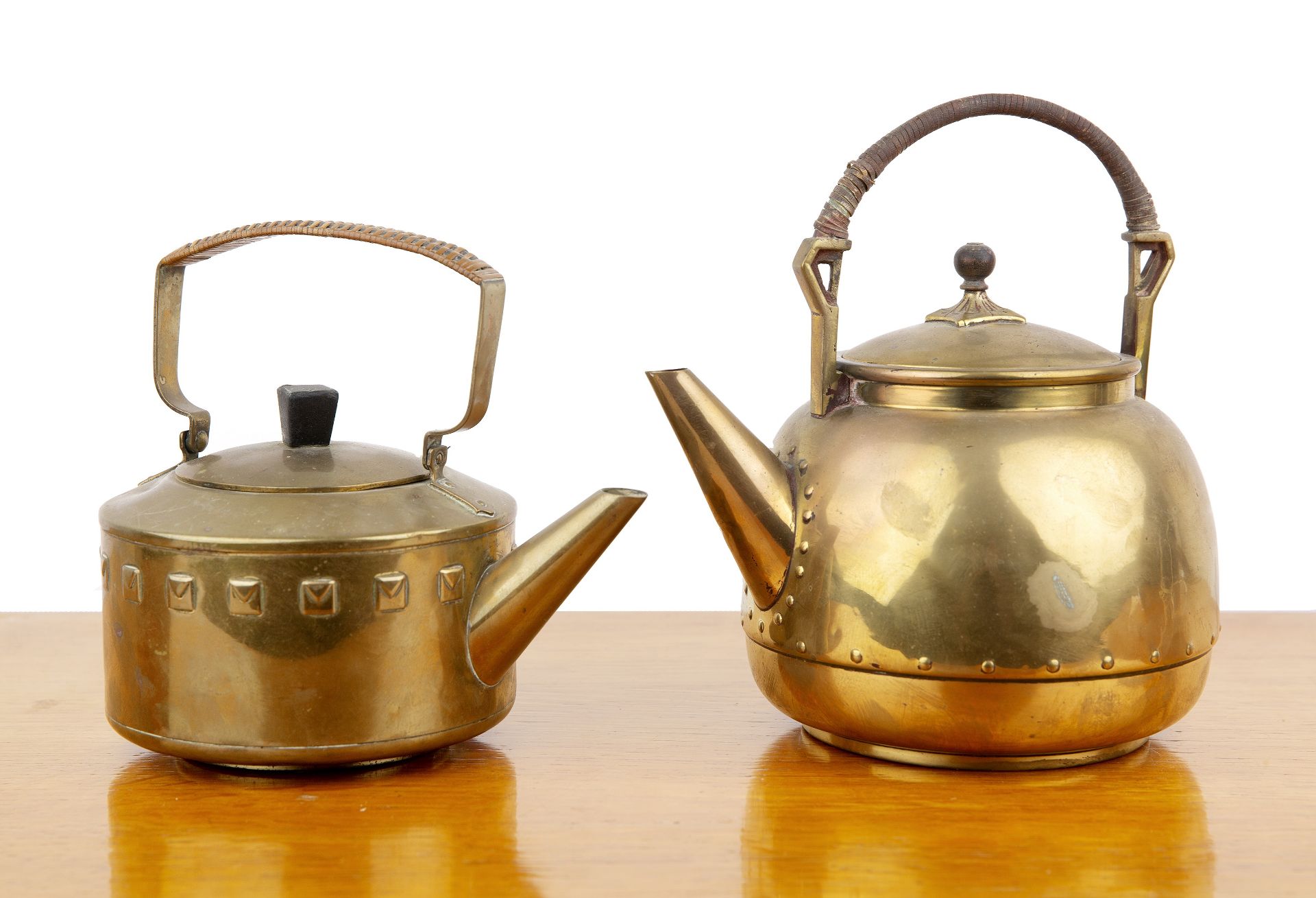 In the manner of WMF (Württembergische Machin Fabrik) two Secessionist style brass kettles or