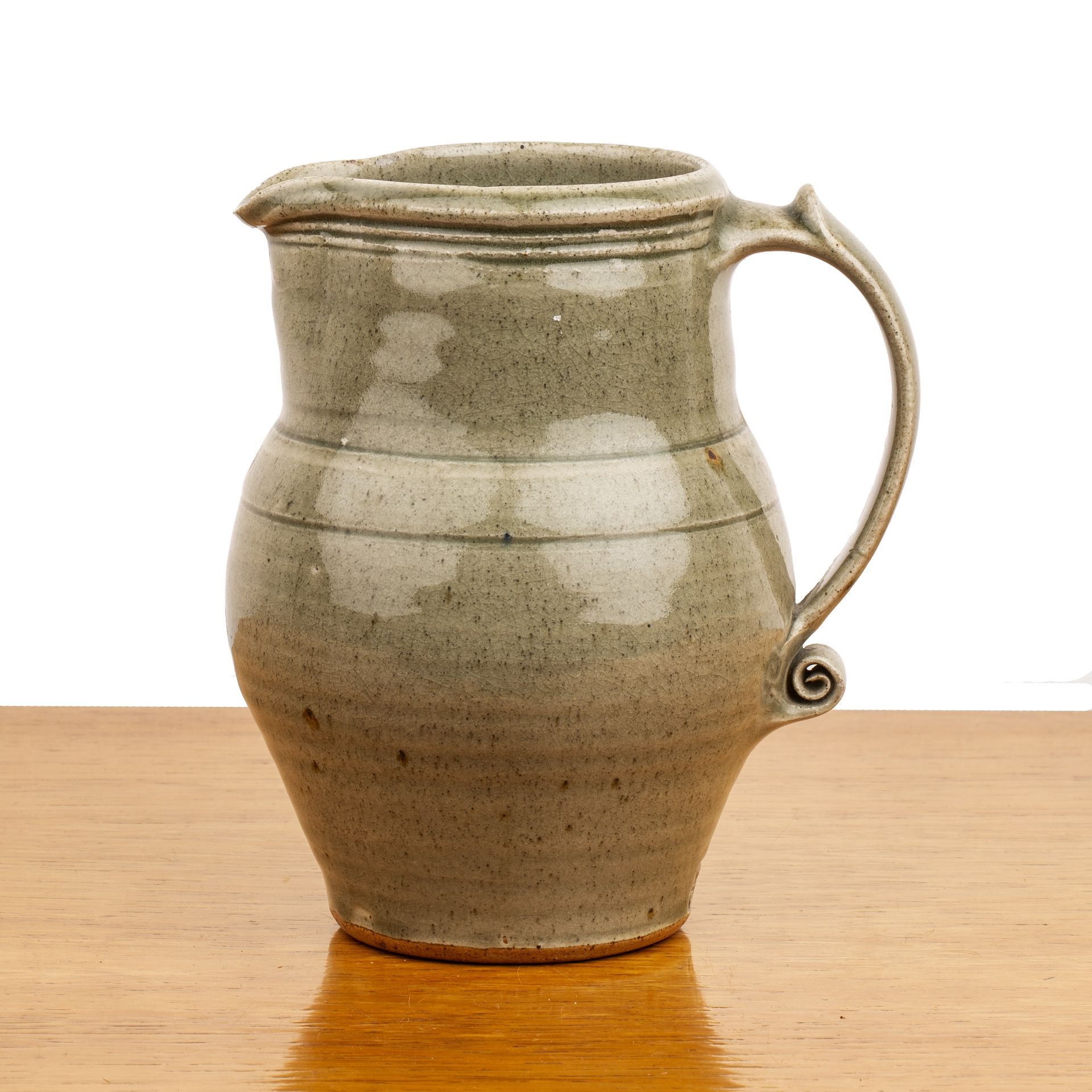 Leach pottery (St. Ives) Standard ware studio pottery jug with scrolling handle and incised banding,
