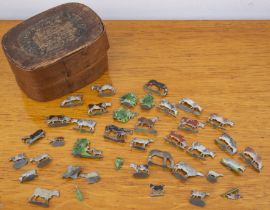 Collection of lead painted cows and related civilian figures, in original wooden box with paper