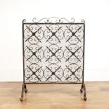 Wrought iron firescreen with mesh and lattice work panel, decorated with flowers, 60cm wide x 77.5cm