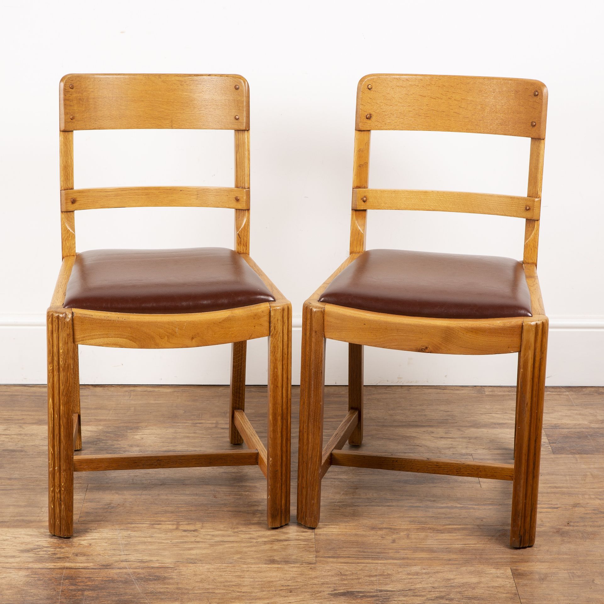 Attributed to Heals pair of oak-framed chairs with bar backs, reupholstered red seats, with stylised